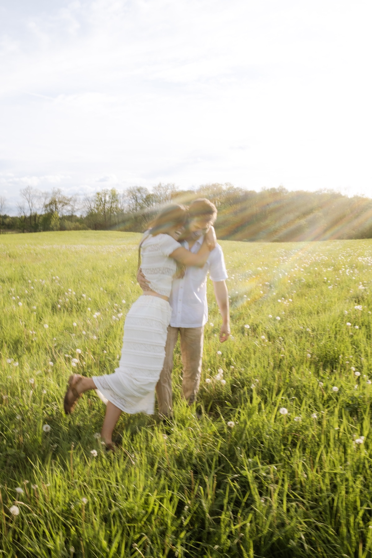 Couple embracing in a sunlit field