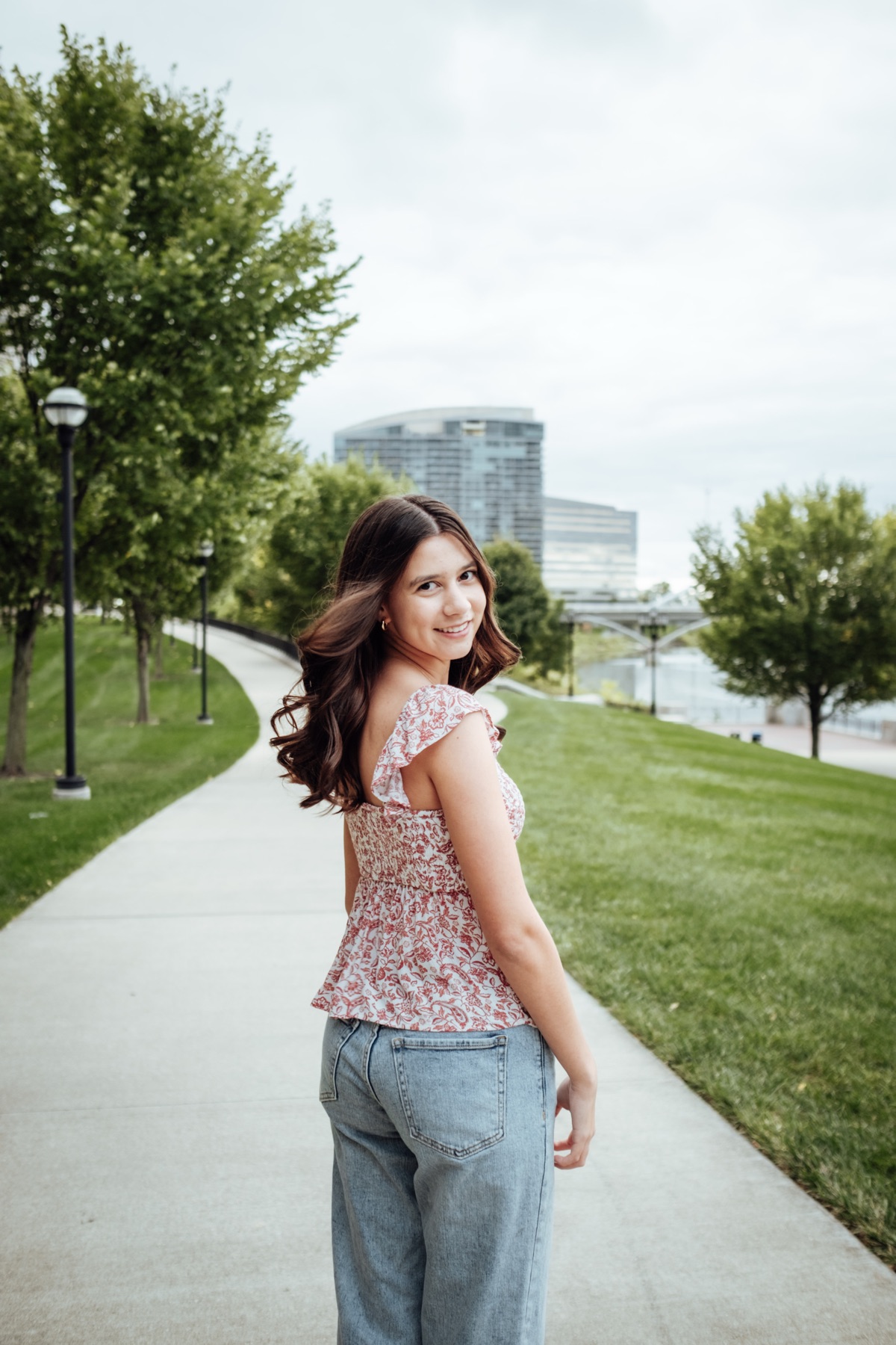 Senior portrait walking, looking back over their shoulder