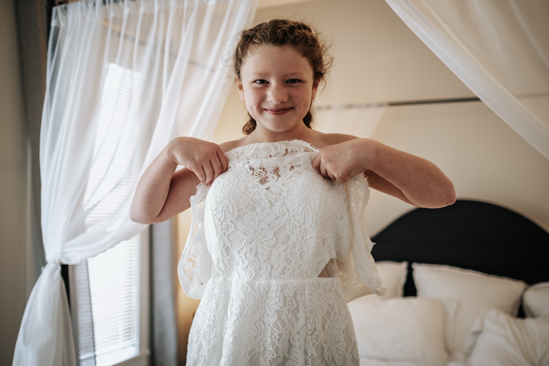 Flower girl getting ready in a white dress